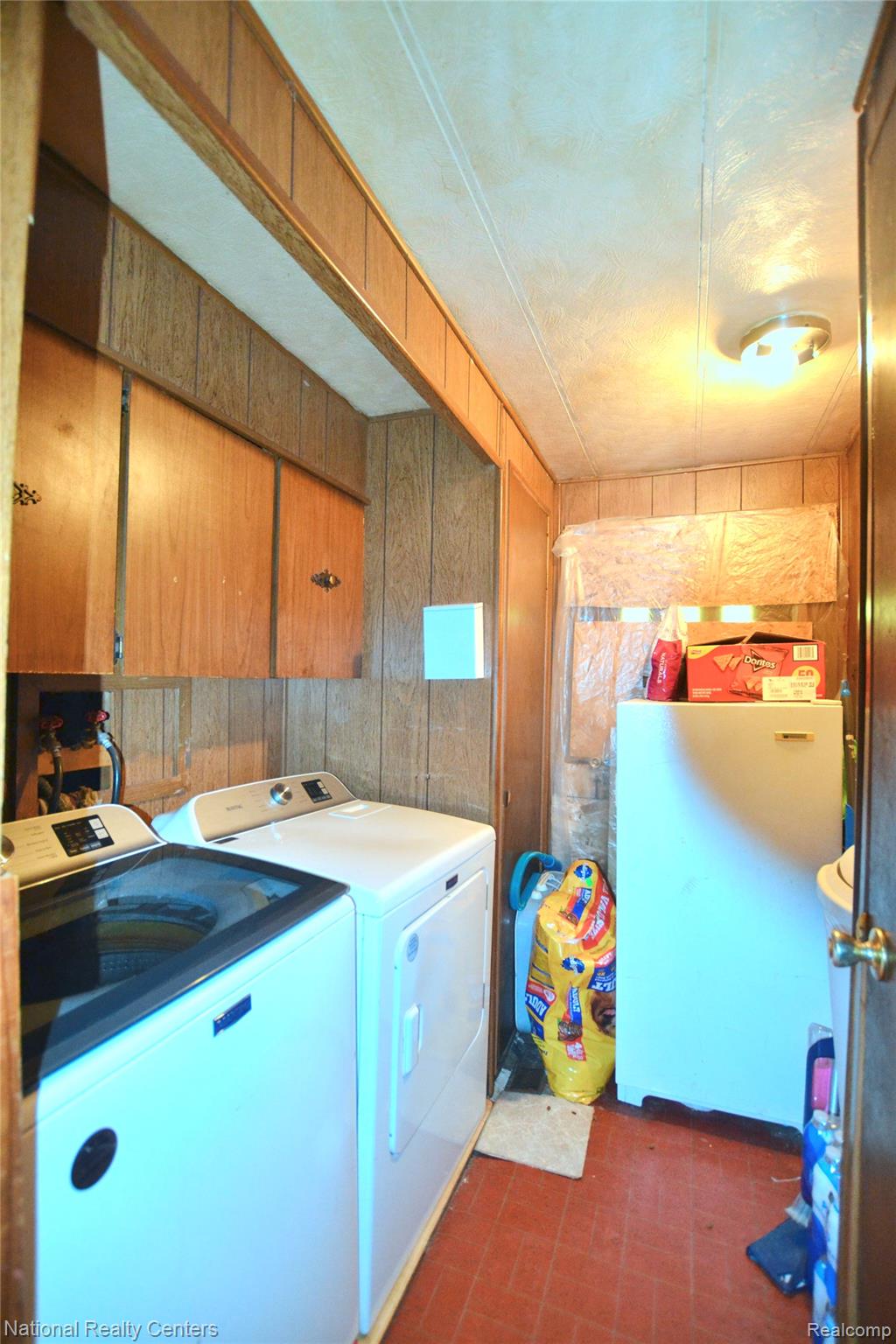 3088 7 Mile Road Sears, MI 49679 - Photo 9 of 27 Laundry area featuring wooden walls, washer and dryer