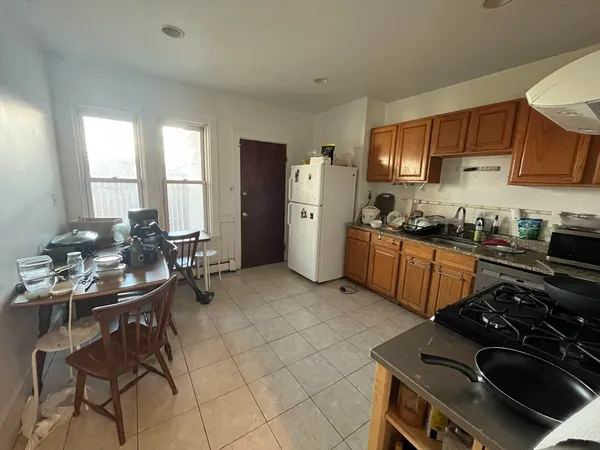 a kitchen with a stove a sink and a refrigerator
