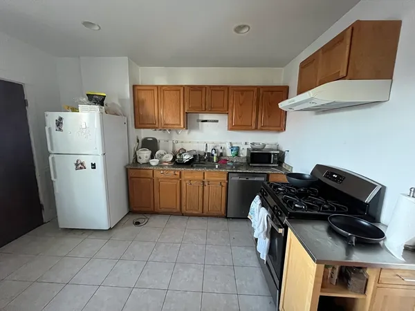 a kitchen with a refrigerator a stove a sink and a cabinets