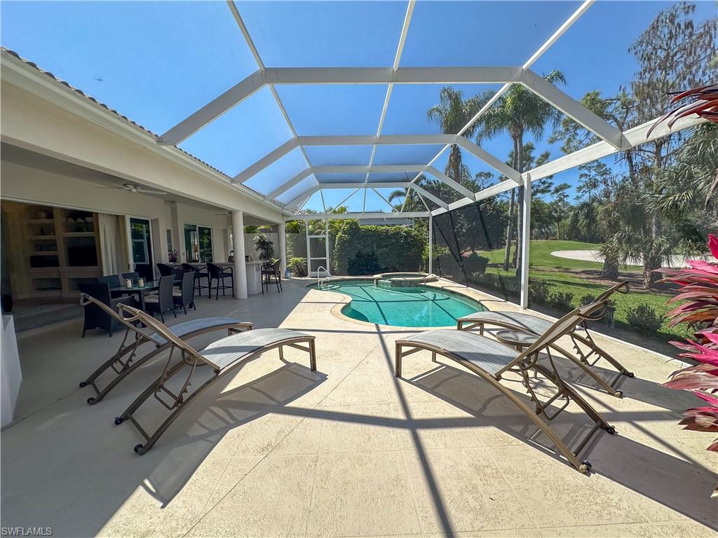 8229 Allendale Court Naples, FL 34120 - Photo 12 of 50 a view of a swimming pool with a patio