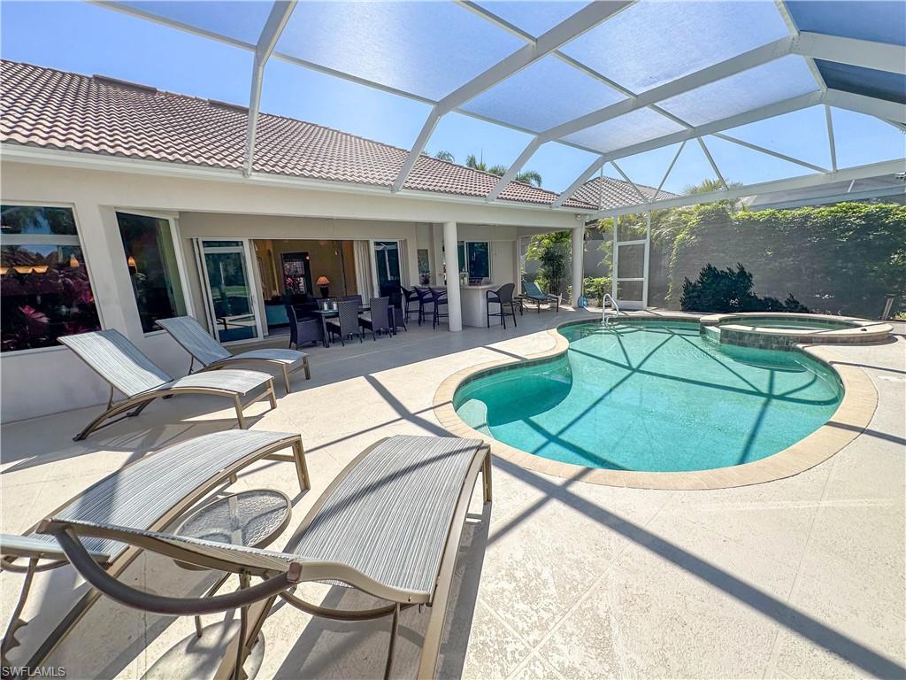 8229 Allendale Court Naples, FL 34120 - Photo 14 of 50 a view of a swimming pool with a patio