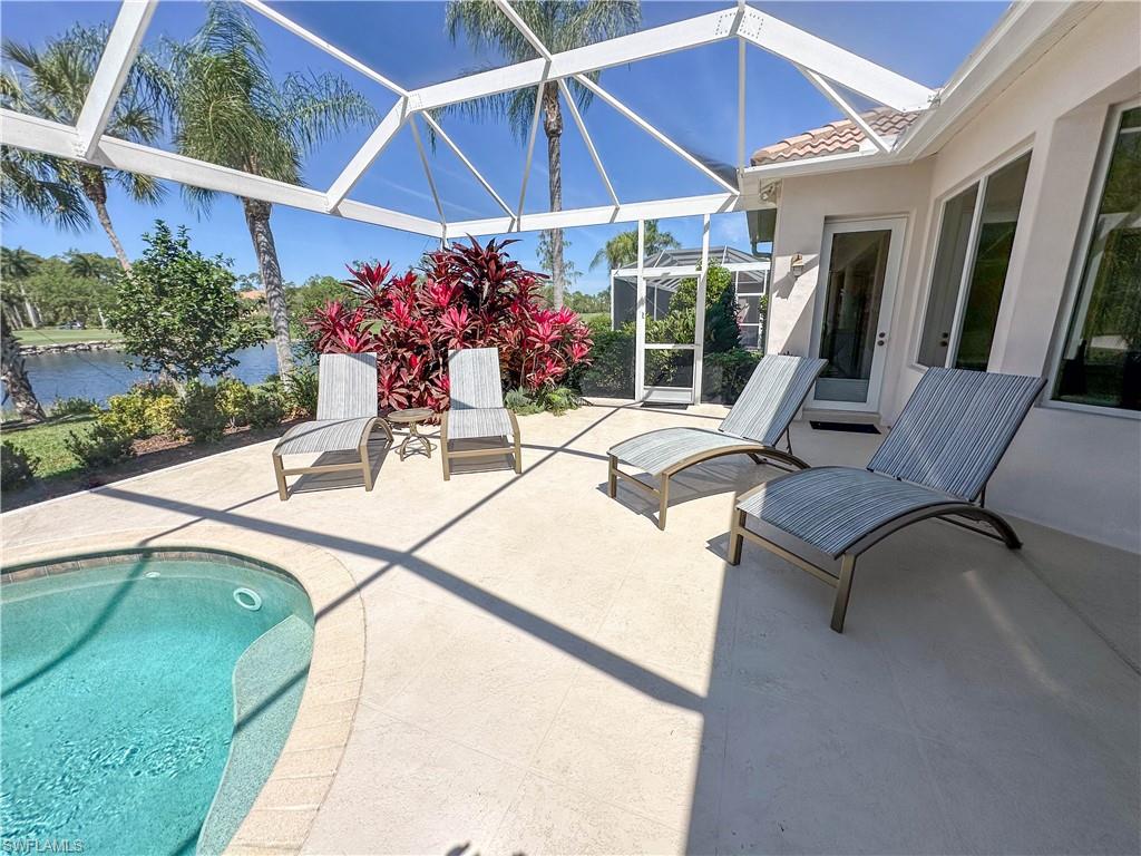 8229 Allendale Court Naples, FL 34120 - Photo 15 of 50 a view of house with swimming pool outdoor seating and porch