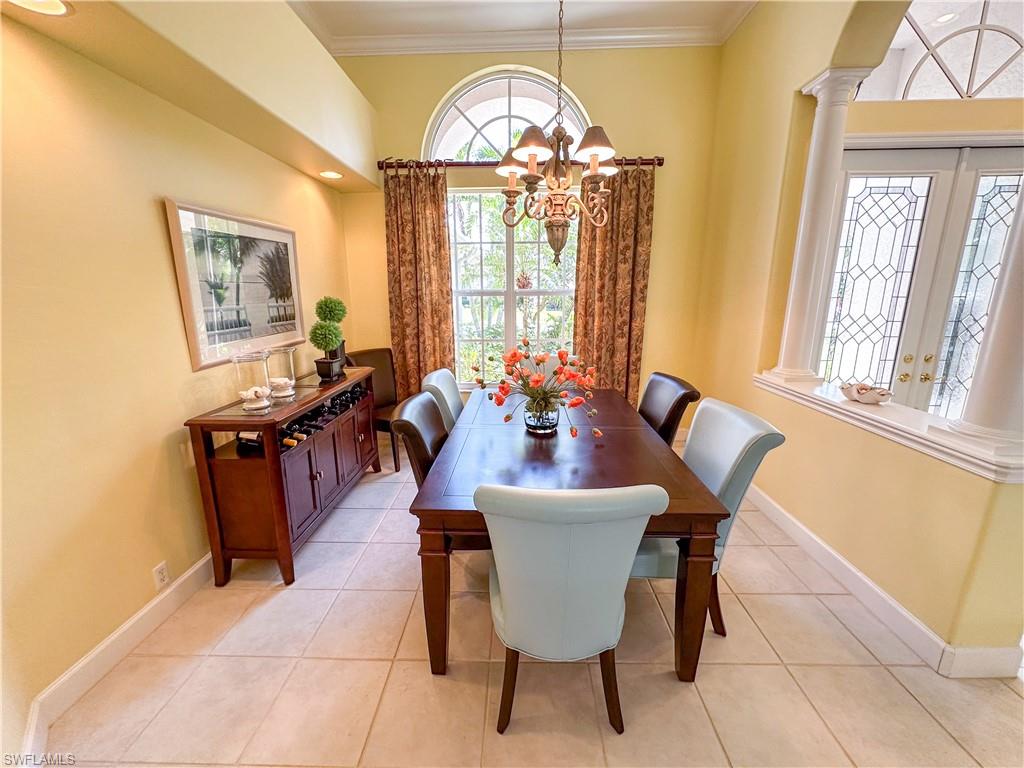 8229 Allendale Court Naples, FL 34120 - Photo 18 of 50 a dining room with furniture a chandelier and wooden floor