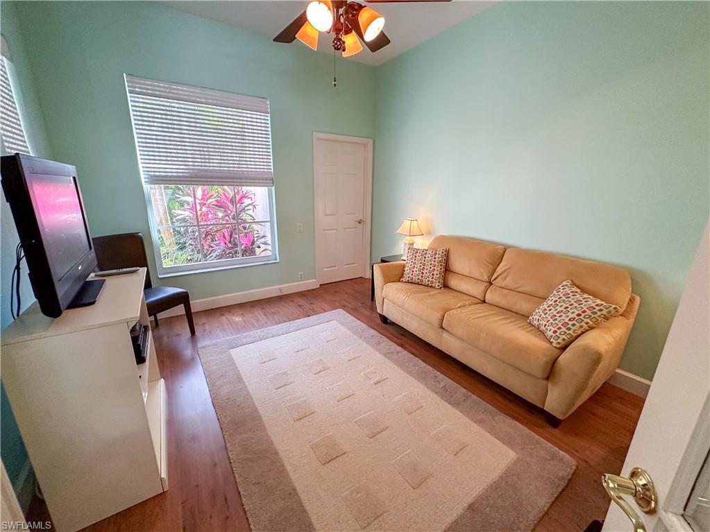 8229 Allendale Court Naples, FL 34120 - Photo 19 of 50 a living room with furniture and a flat screen tv