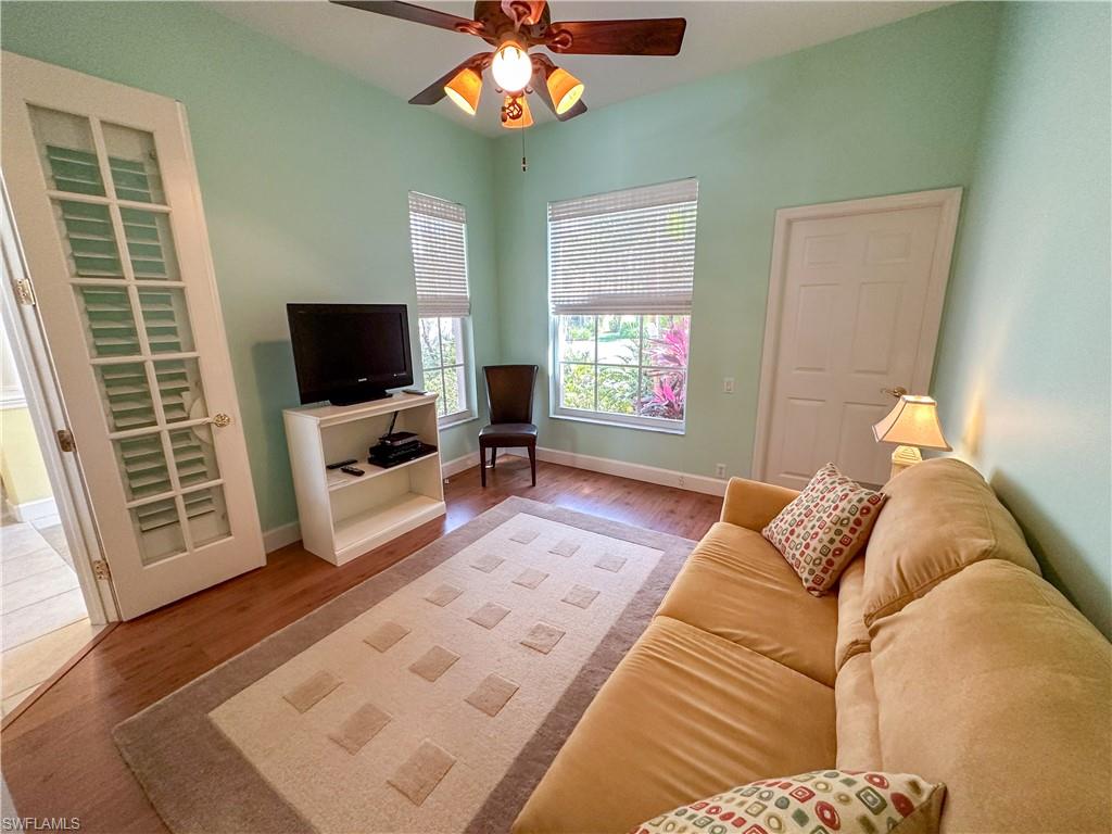 8229 Allendale Court Naples, FL 34120 - Photo 20 of 50 a living room with furniture and a flat screen tv
