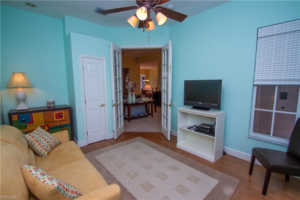 8229 Allendale Court Naples, FL 34120 - Photo 21 of 50 a living room with furniture and a flat screen tv