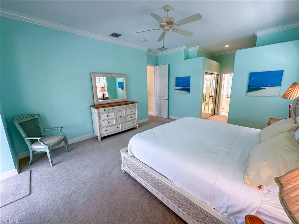 8229 Allendale Court Naples, FL 34120 - Photo 24 of 50 a spacious bedroom with a bed and a chair