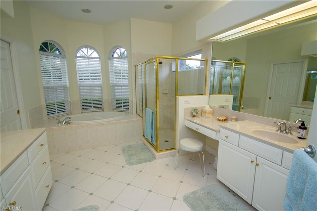 8229 Allendale Court Naples, FL 34120 - Photo 26 of 50 a bathroom with a double vanity sink toilet and shower