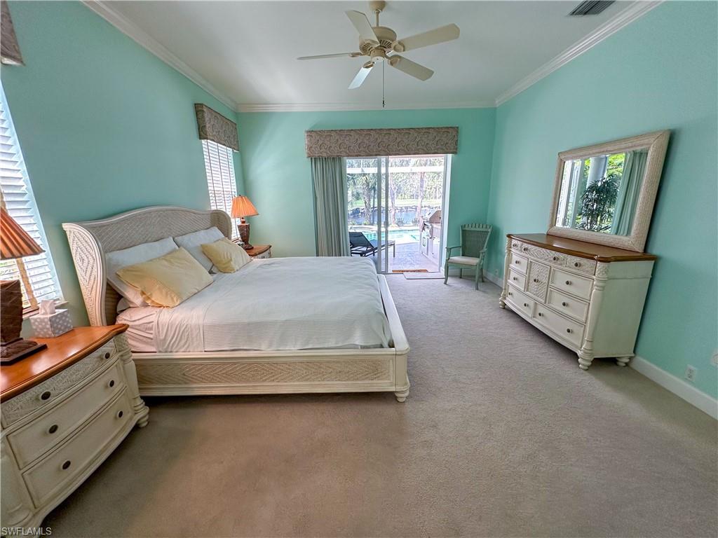 8229 Allendale Court Naples, FL 34120 - Photo 27 of 50 a spacious bedroom with a bed and a window