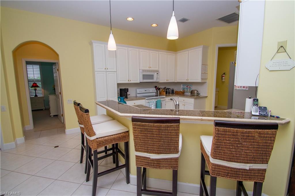 8229 Allendale Court Naples, FL 34120 - Photo 28 of 50 a kitchen with a sink cabinets and window