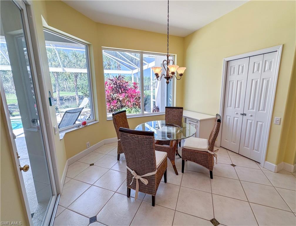 8229 Allendale Court Naples, FL 34120 - Photo 29 of 50 a dining room with furniture and chandelier kitchen view