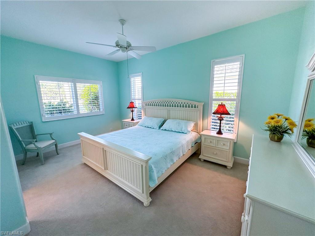 8229 Allendale Court Naples, FL 34120 - Photo 33 of 50 a bedroom with a bed and a chandelier