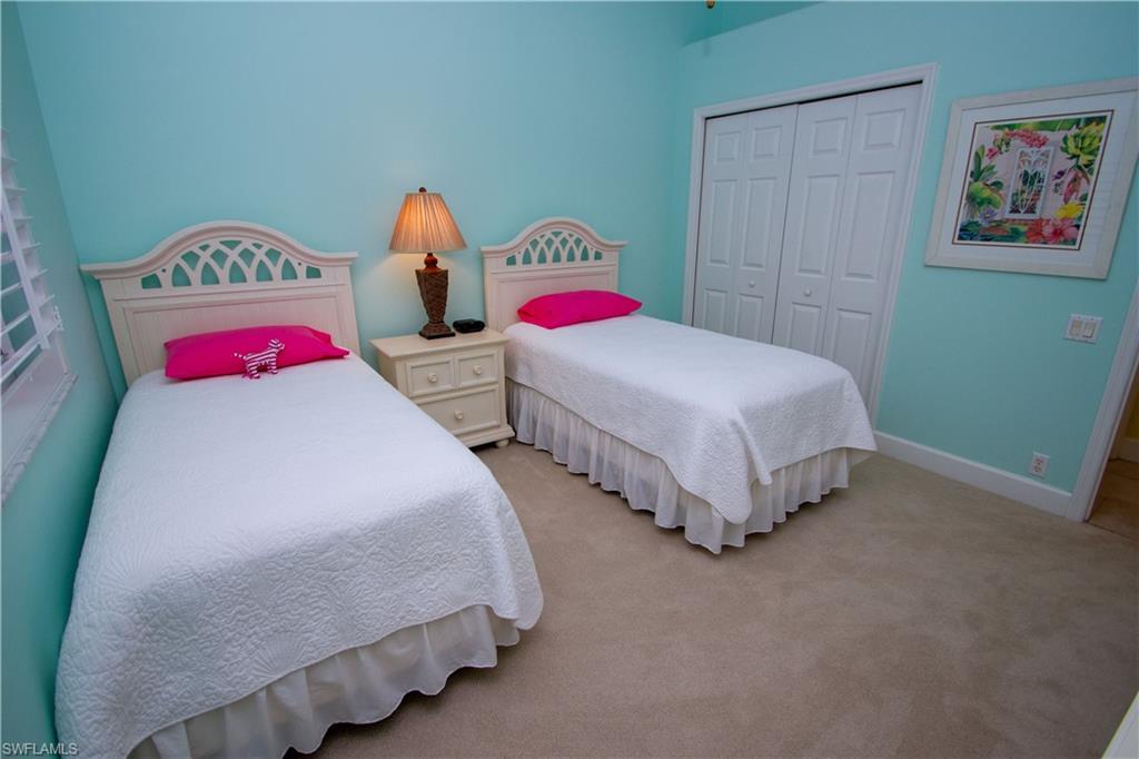 8229 Allendale Court Naples, FL 34120 - Photo 36 of 50 a bedroom with two beds and painting on the wall