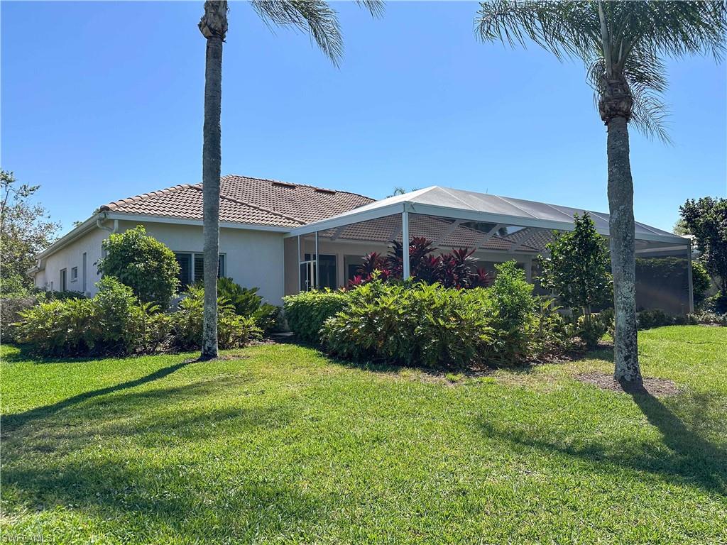 8229 Allendale Court Naples, FL 34120 - Photo 38 of 50 a front view of a house with a yard and potted plants
