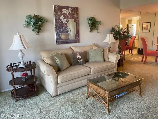 a living room with furniture and a lamp