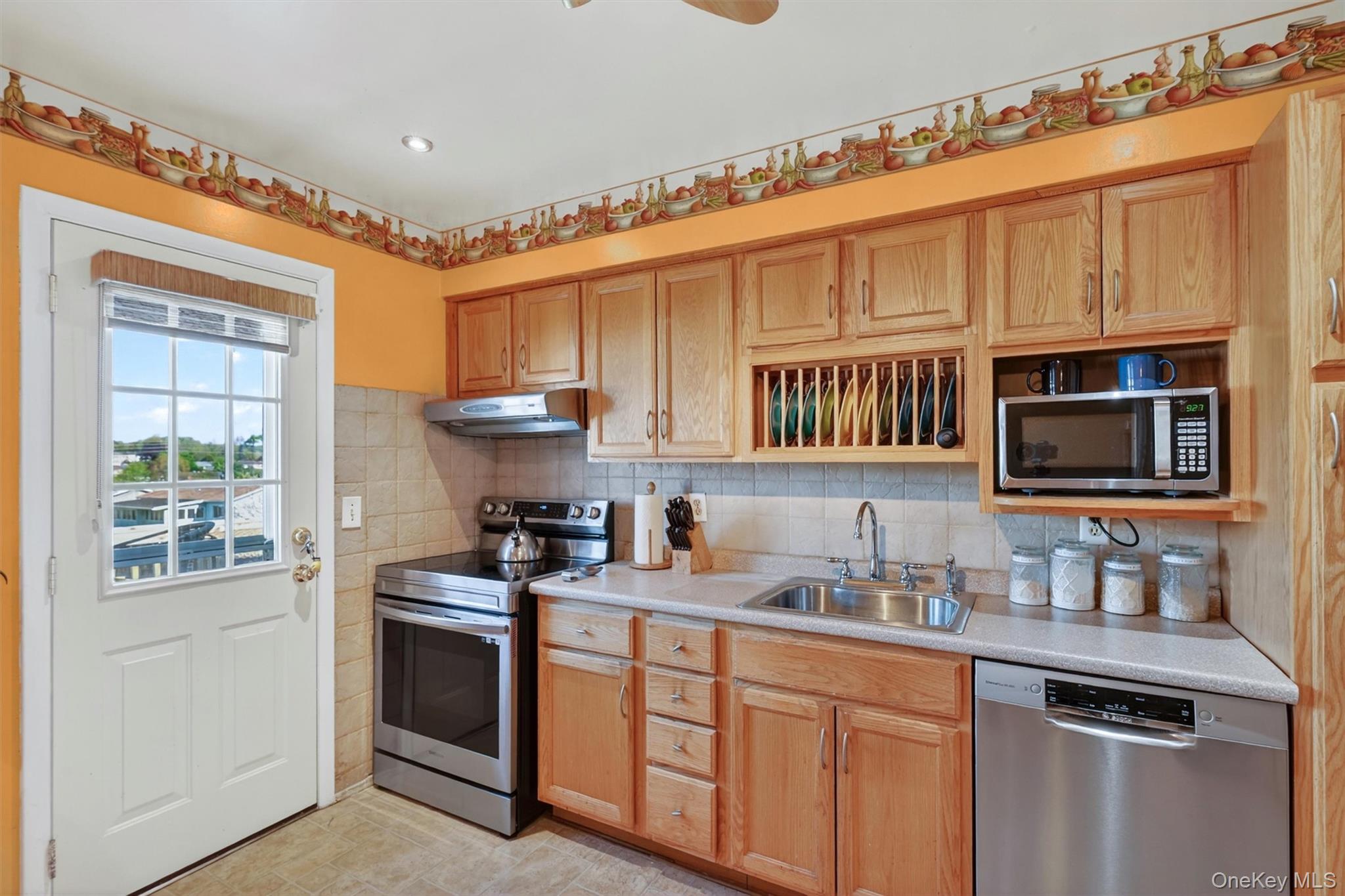 122 Rolling Meadows Road Middletown, NY 10940 - Photo 15 of 47 a kitchen with stainless steel appliances granite countertop a stove sink microwave and cabinets
