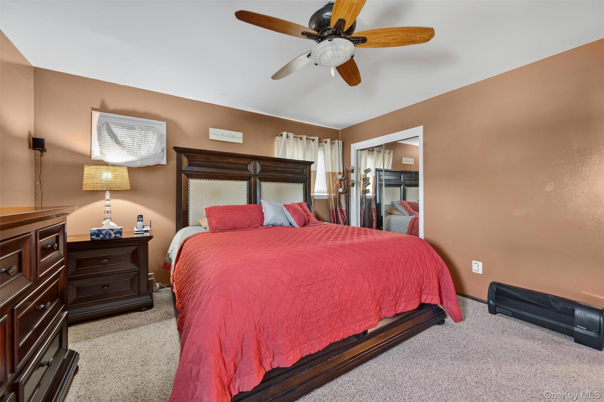 122 Rolling Meadows Road Middletown, NY 10940 - Photo 17 of 47 a bed room with a bed and a chandelier