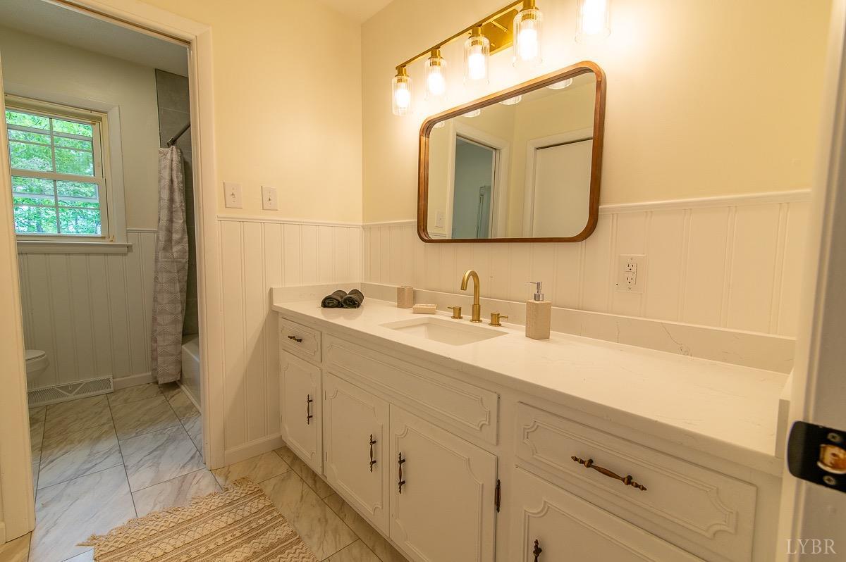 219 Izaak Walton Road Amherst, VA 24521 - Photo 16 of 32 a bathroom with a sink vanity and mirror
