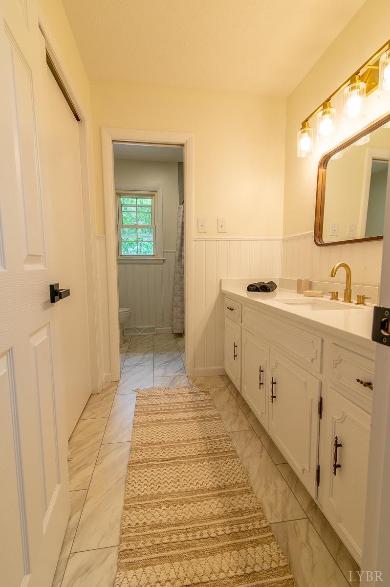 219 Izaak Walton Road Amherst, VA 24521 - Photo 17 of 32 a bathroom with a sink and a mirror