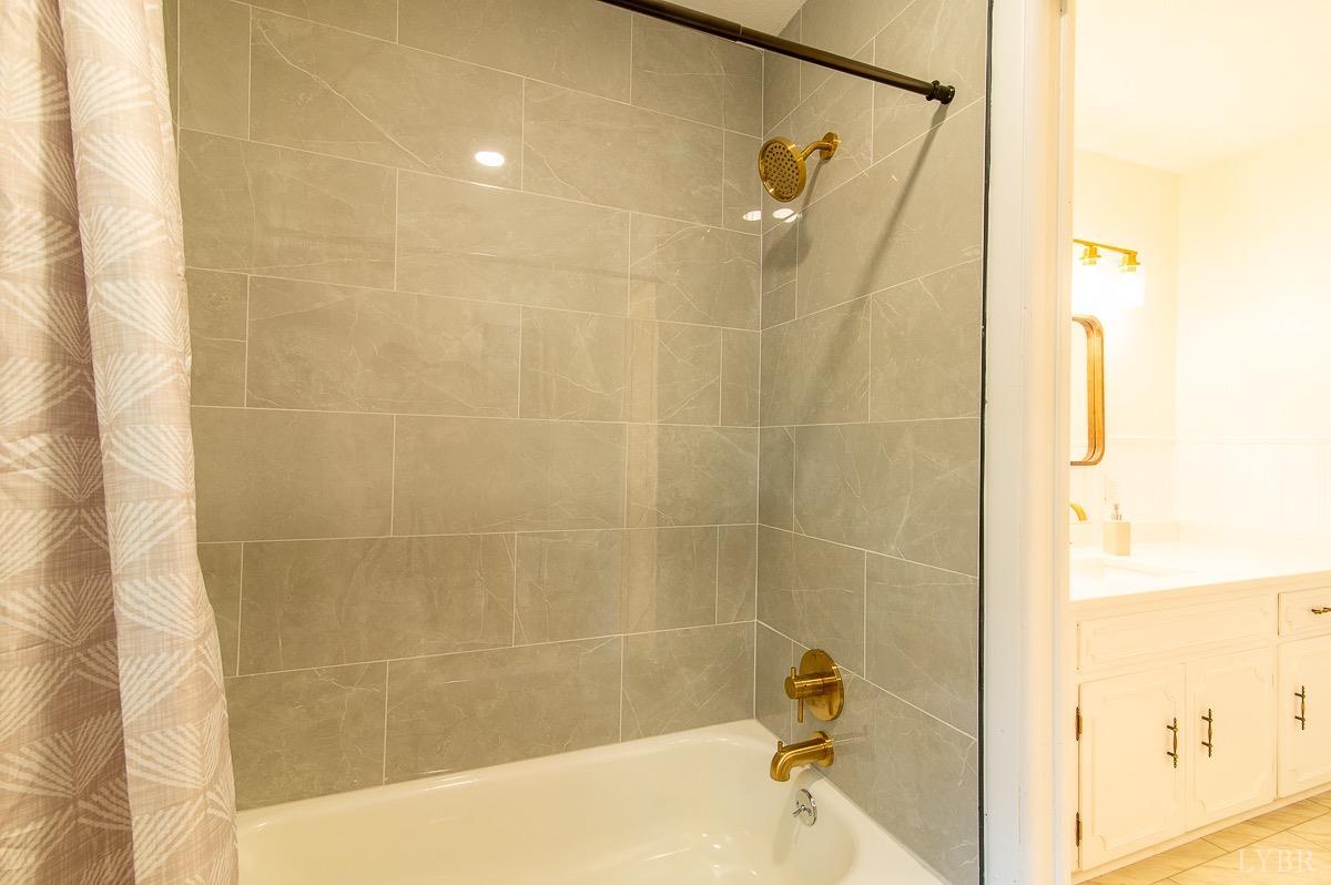 219 Izaak Walton Road Amherst, VA 24521 - Photo 18 of 32 a bathroom with a shower and a bathtub