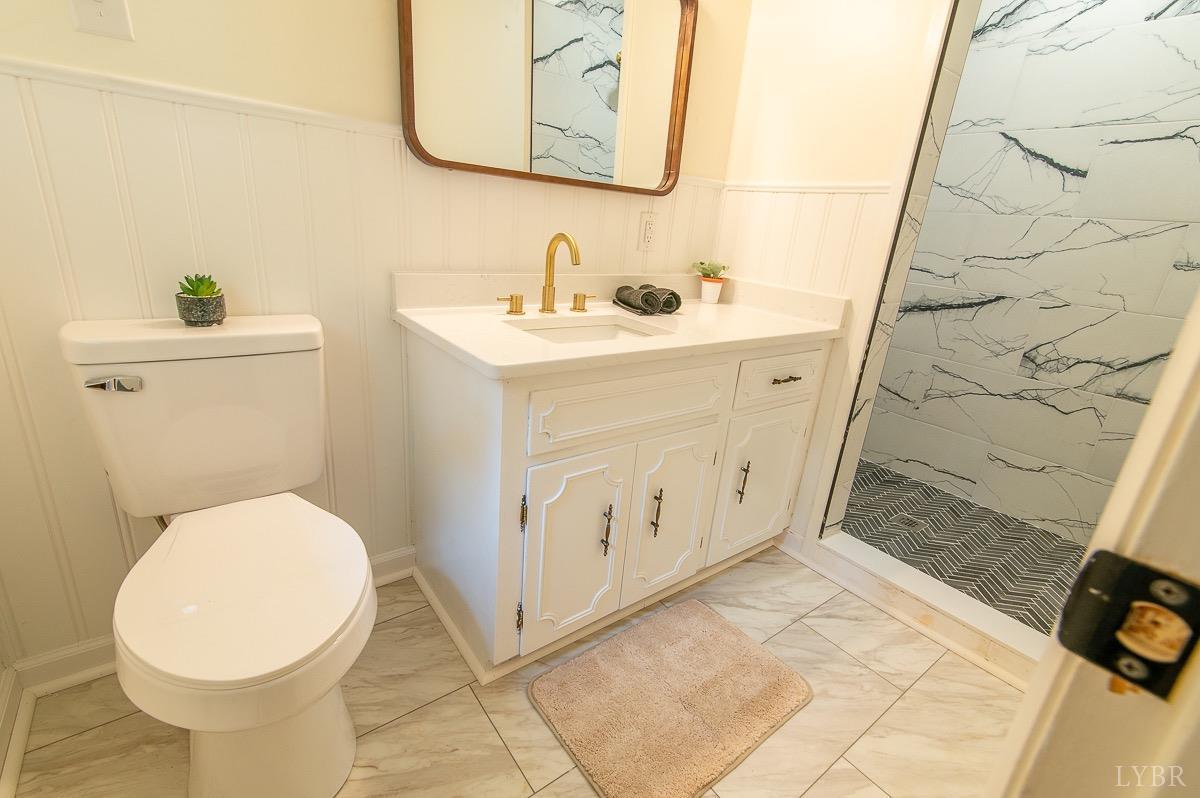 219 Izaak Walton Road Amherst, VA 24521 - Photo 24 of 32 a bathroom with a sink a toilet and shower