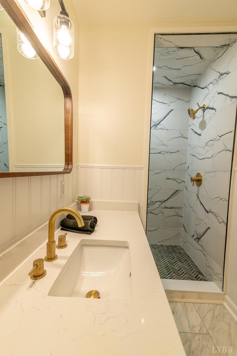 219 Izaak Walton Road Amherst, VA 24521 - Photo 25 of 32 a bathroom with a sink and a shower