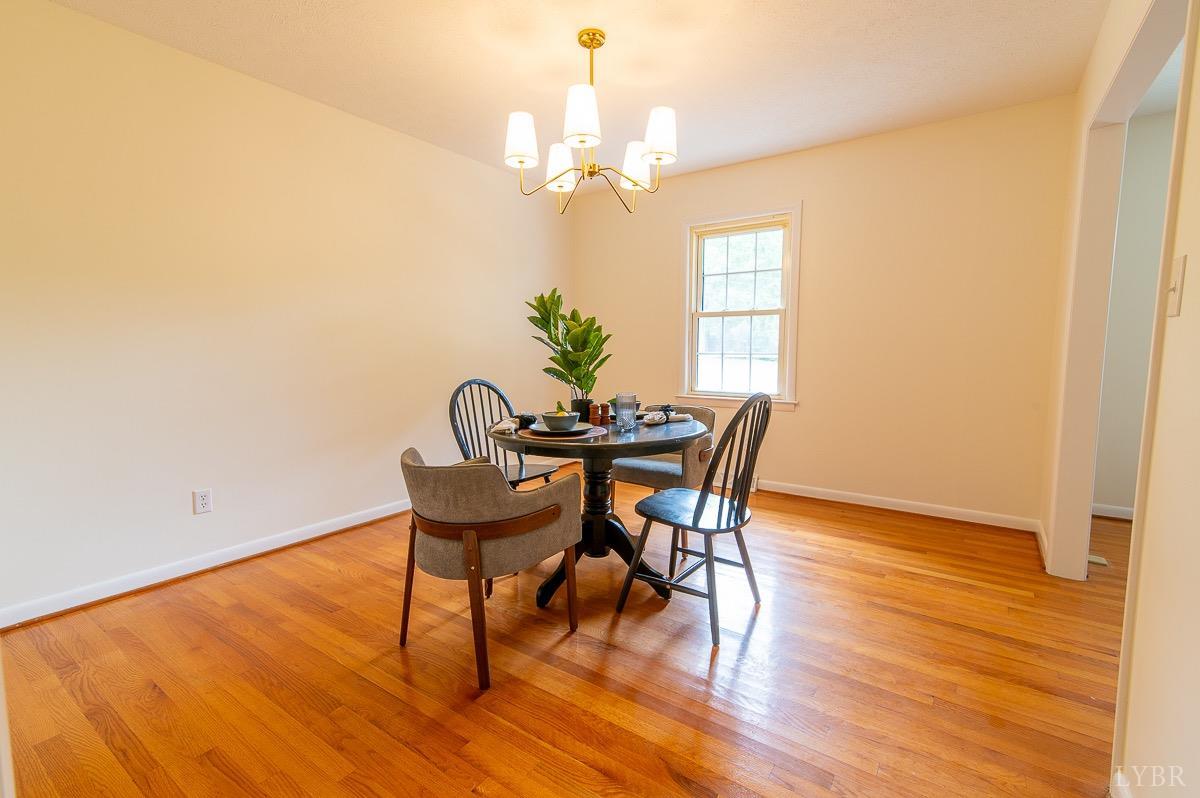 219 Izaak Walton Road Amherst, VA 24521 - Photo 8 of 32 a view of a dining room with furniture and wooden floor