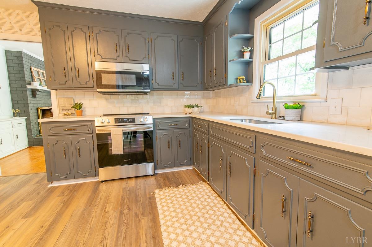 219 Izaak Walton Road Amherst, VA 24521 - Photo 9 of 32 a kitchen with stainless steel appliances granite countertop a sink and cabinets