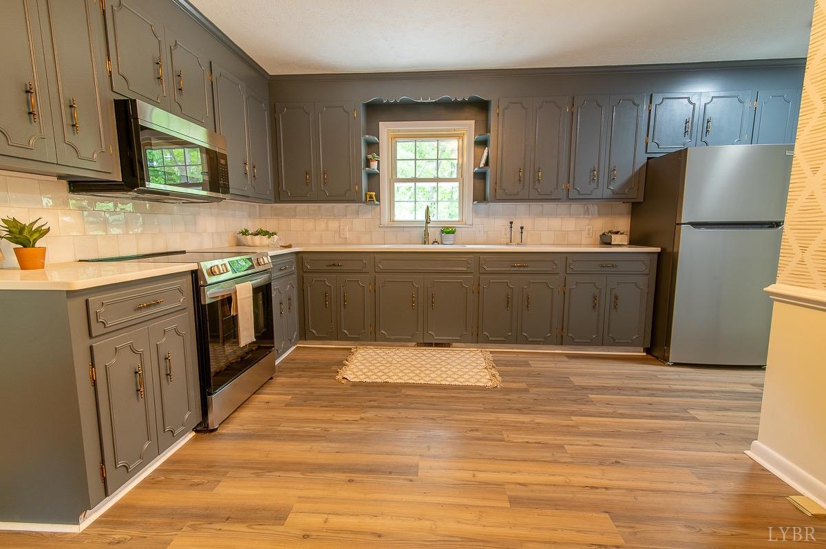 219 Izaak Walton Road Amherst, VA 24521 - Photo 10 of 32 a large kitchen with stainless steel appliances granite countertop a sink stove and refrigerator