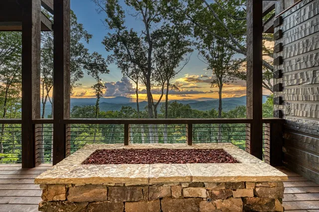a view of a kitchen with a table and chairs in it