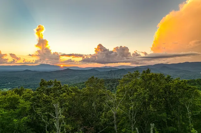 a kitchen with stainless steel appliances granite countertop a sink a refrigerator and wooden cabinets