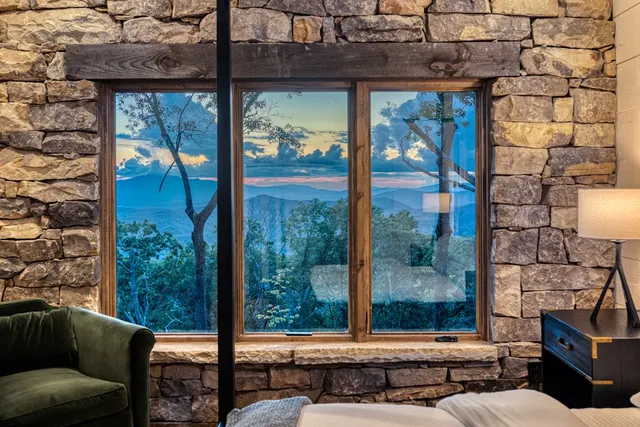 a bed sitting in a bedroom next to a window