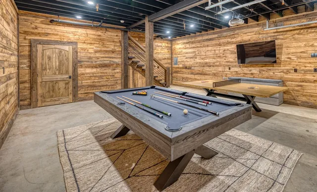 an aerial view of a house with a yard and lake view