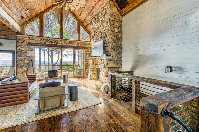 a living room with furniture and a floor to ceiling window