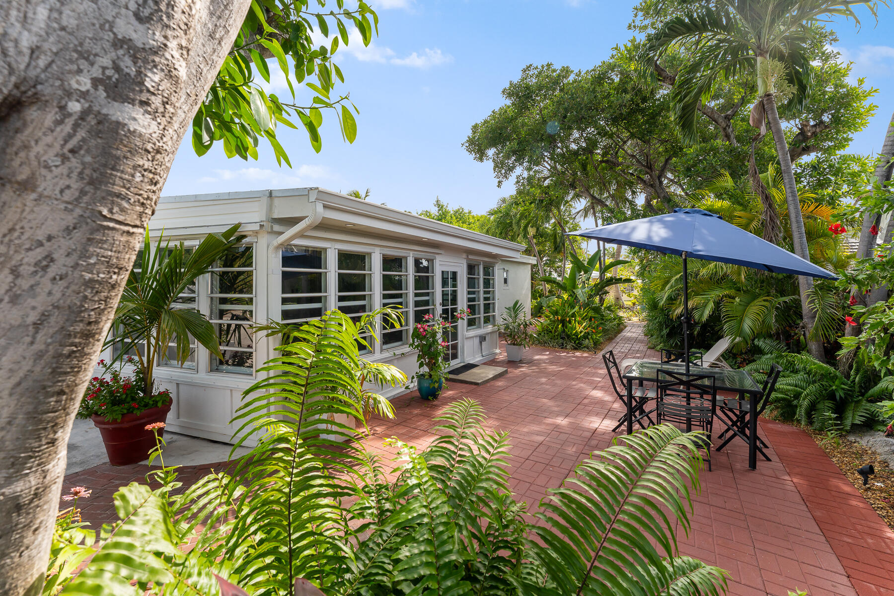 1513 5th Street Key West, FL 33040 - Photo 14 of 19 a view of a house with backyard sitting area and garden