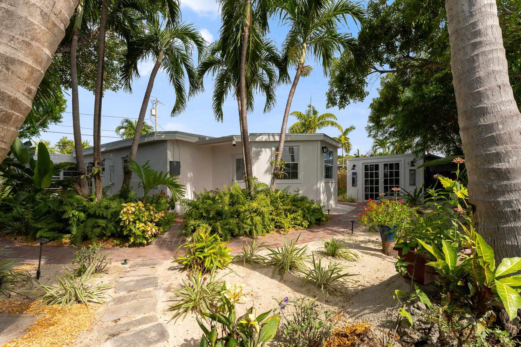 1513 5th Street Key West, FL 33040 - Photo 16 of 19 a front view of a house with a garden