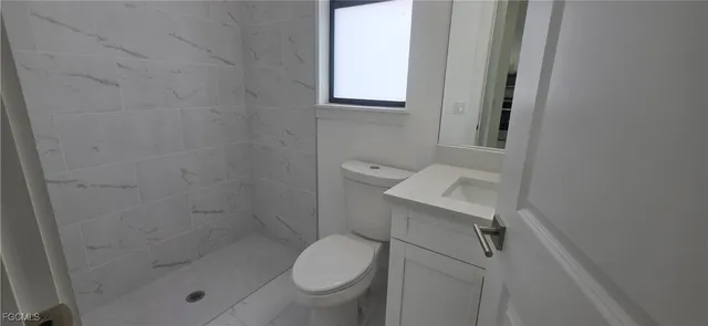 a bathroom with a toilet and a shower
