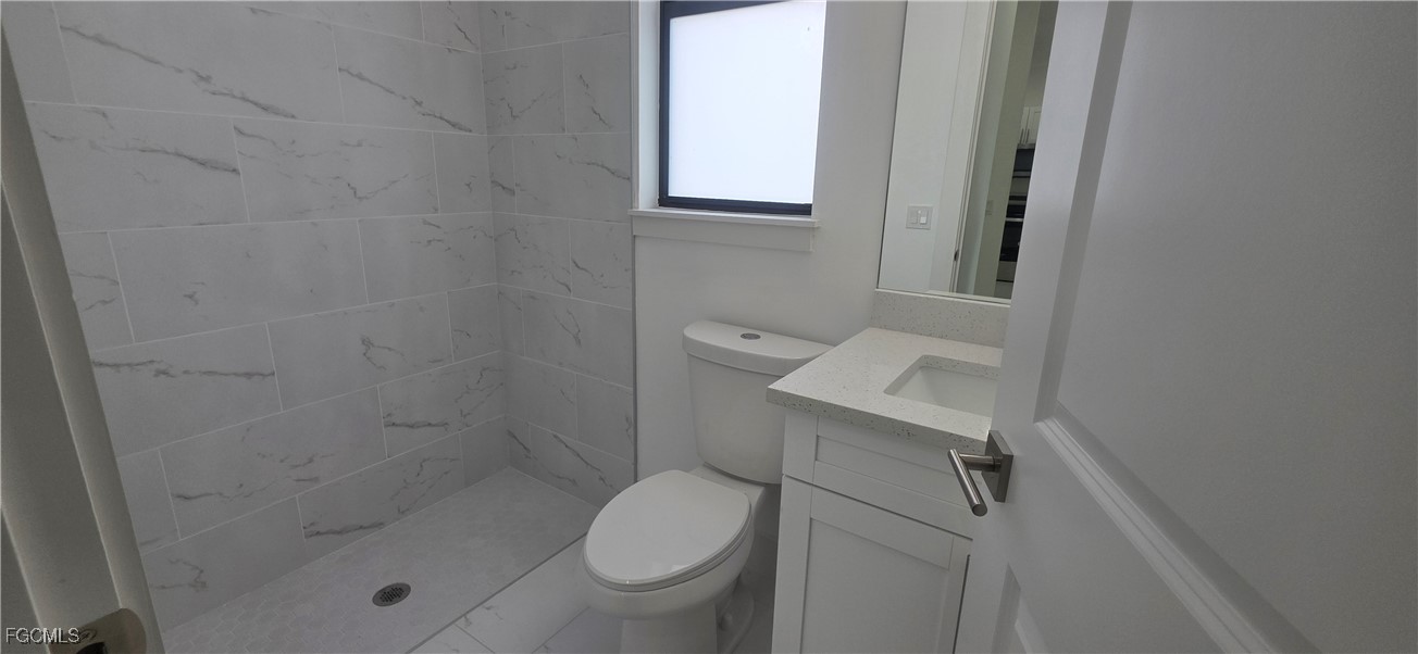 927 Chenault Street Lehigh Acres, FL 33974 - Photo 11 of 16 a bathroom with a toilet and a shower
