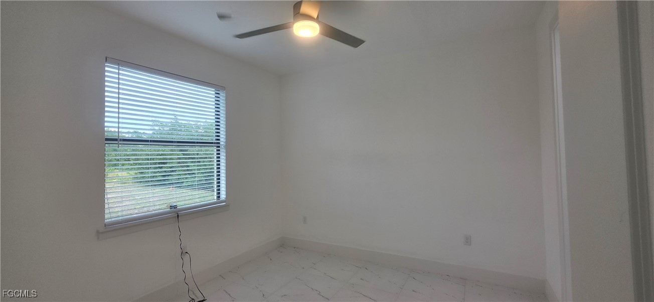927 Chenault Street Lehigh Acres, FL 33974 - Photo 14 of 16 a view of an empty room with a window