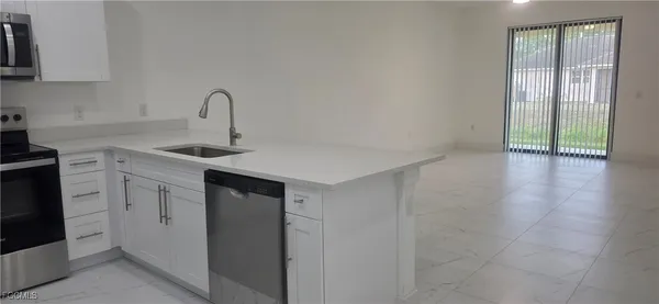a kitchen with a sink cabinets and appliances