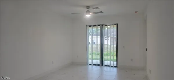 a view of an empty room with a window