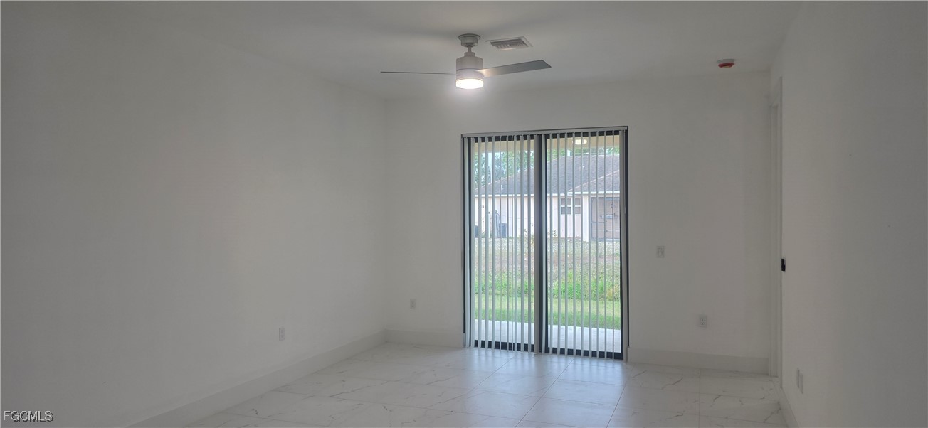 927 Chenault Street Lehigh Acres, FL 33974 - Photo 6 of 16 a view of an empty room with a window