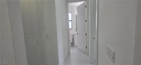a view of a bathroom from a hallway