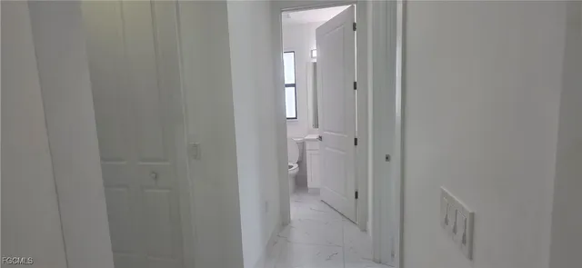 a view of a bathroom from a hallway