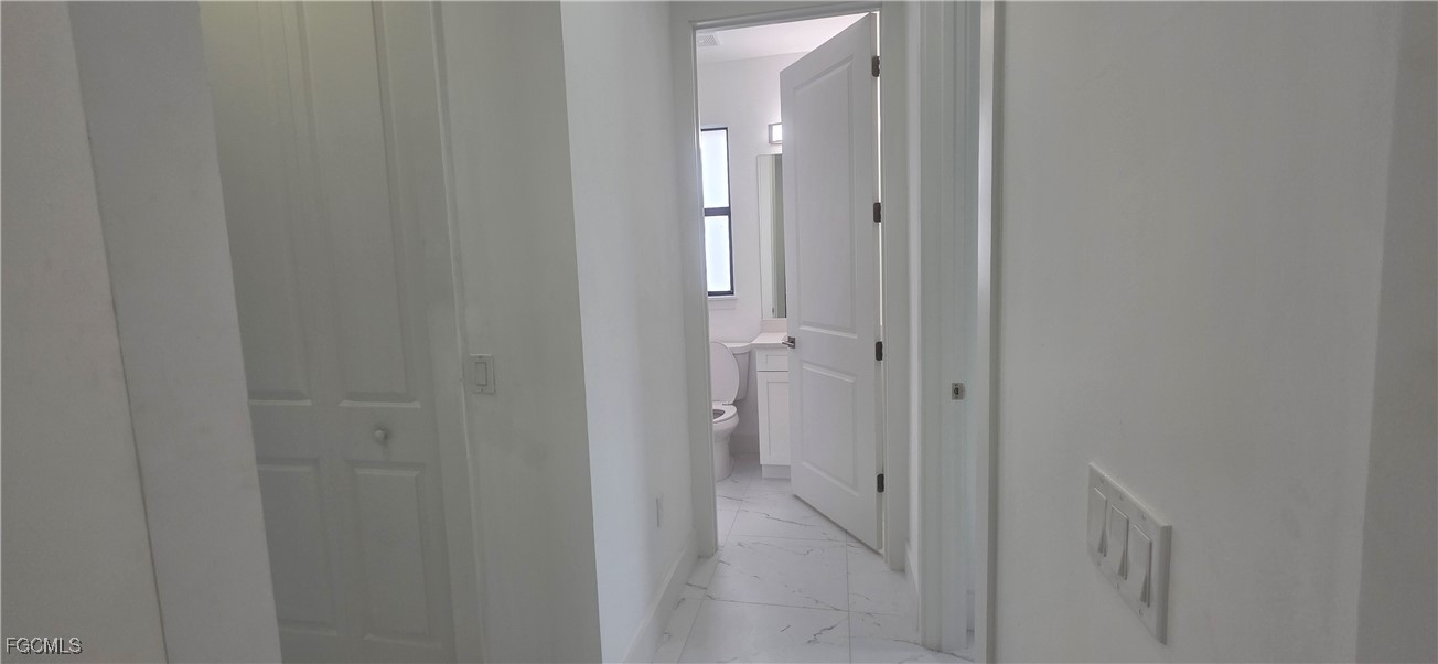 927 Chenault Street Lehigh Acres, FL 33974 - Photo 8 of 16 a view of a bathroom from a hallway