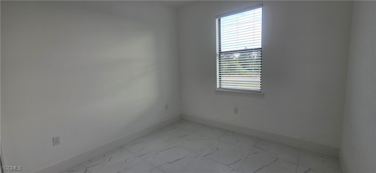 927 Chenault Street Lehigh Acres, FL 33974 - Photo 9 of 16 an empty room with a window