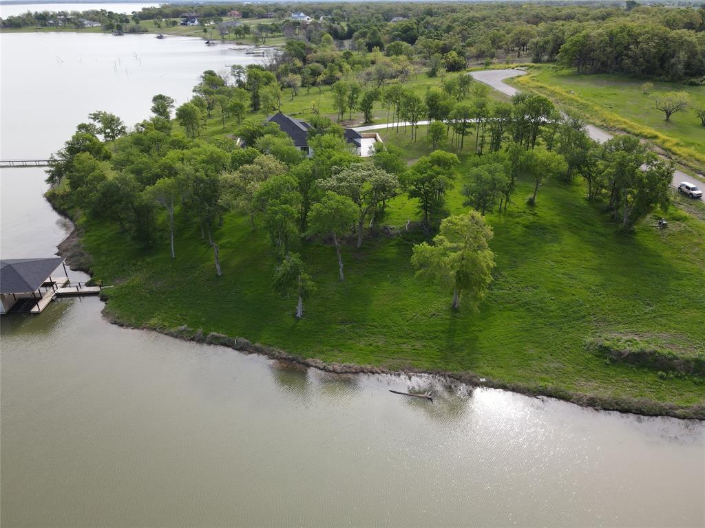 117 Diamond Point Drive Corsicana, TX 75109 - Photo 19 of 35 a view of a lake with a yard and large trees