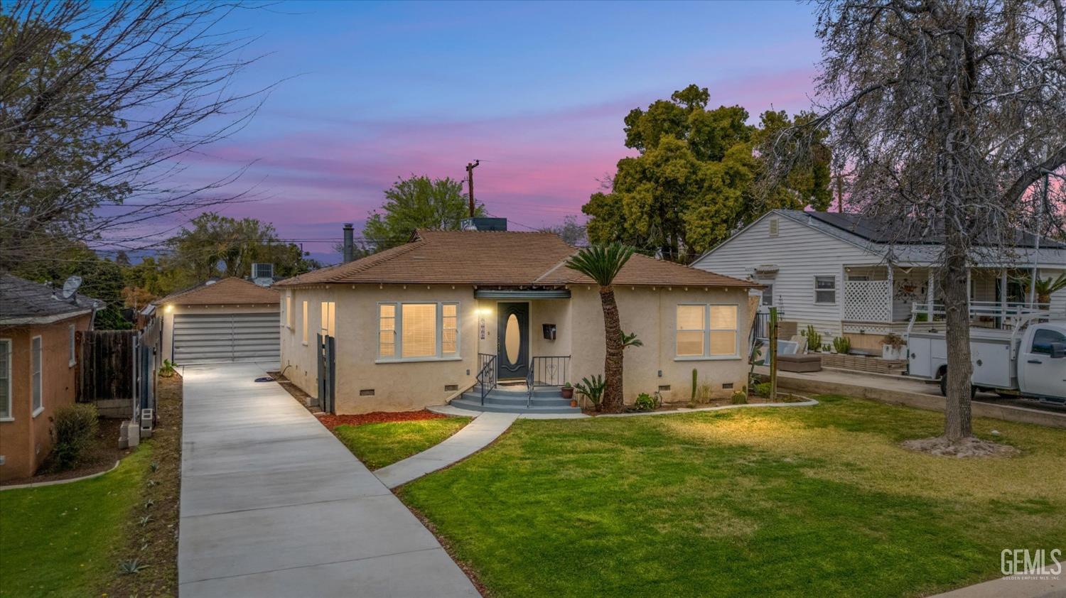 a front view of a house with yard and green space