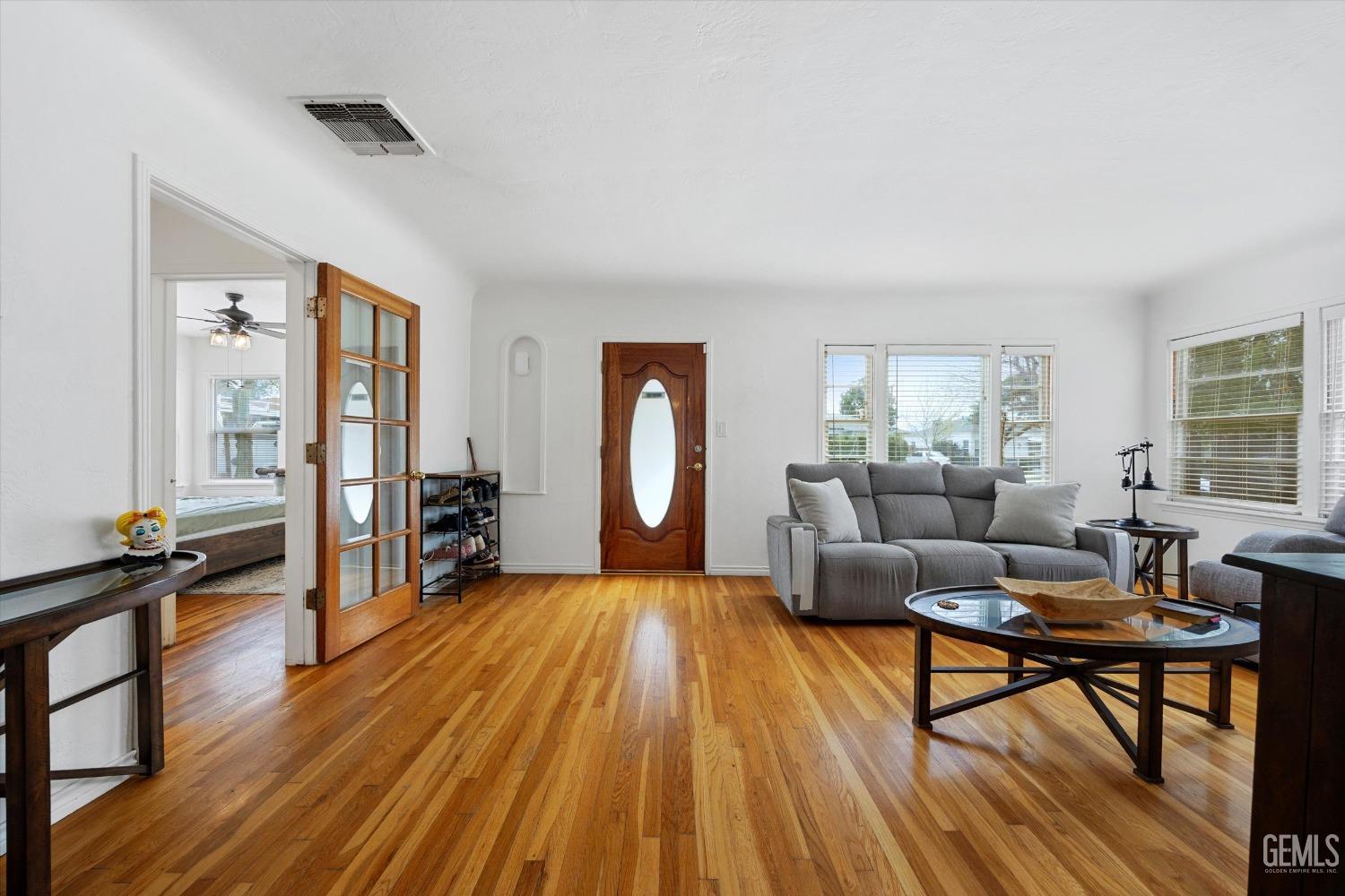 Undisclosed Address Bakersfield, CA 93305 - Photo 13 of 46 a living room with furniture and a wooden floor