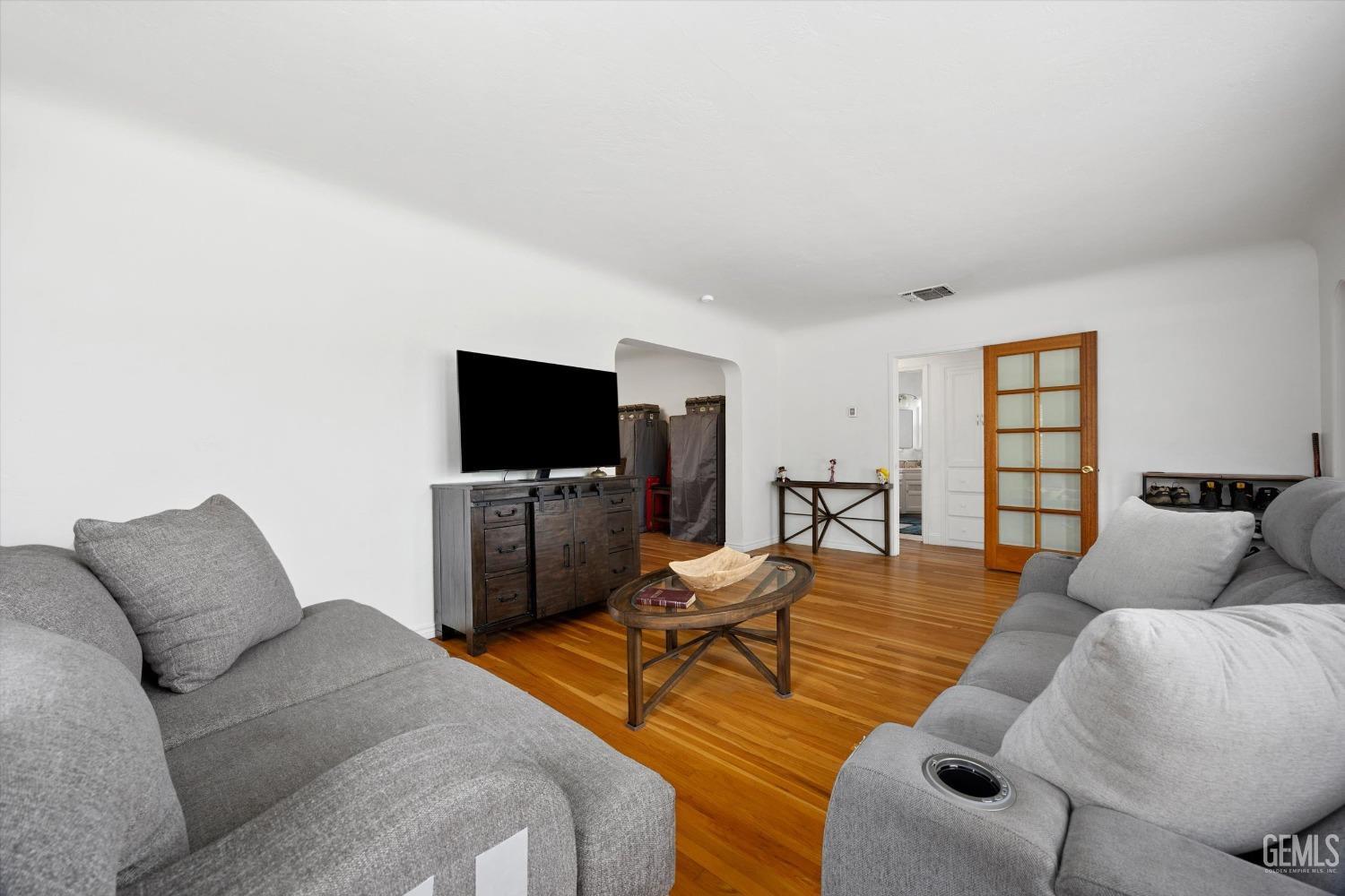 Undisclosed Address Bakersfield, CA 93305 - Photo 15 of 46 a living room with furniture and a flat screen tv